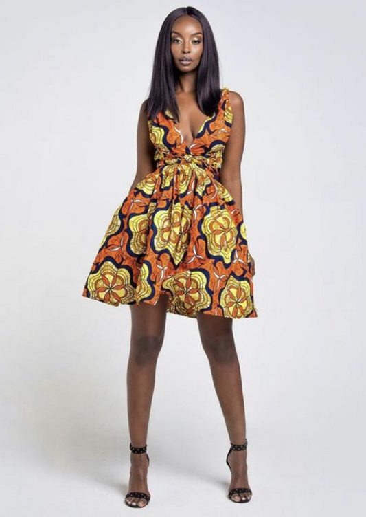 An orange multi way wrap dress, The Lola, is a versatile African print dress that can be styled to match your mood or the occasion. The Ankara style dress can be worn as a chic halter neck midi dress, a sleeveless v neck dress, a wrap dress, a bandeau midi dress, a cross front dress and more. The orange midi dress is perfect for work and social occasions and the wrap skater dress is made to measure.