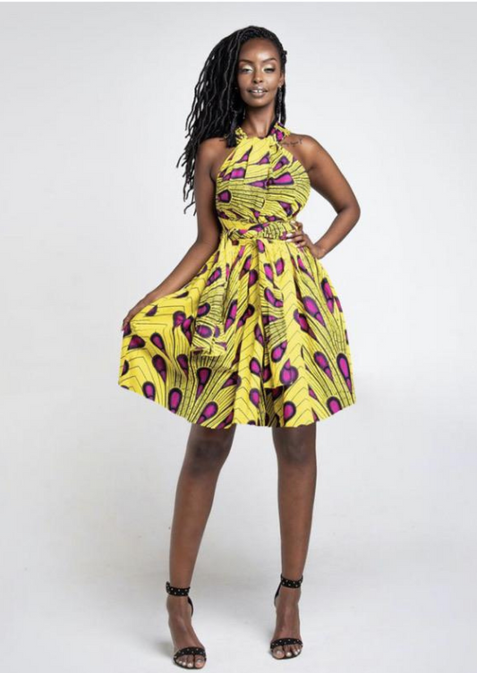A yellow multi way wrap dress, The Lola, is a versatile African print dress that can be styled to match your mood or the occasion. The Ankara style dress can be worn as a chic halter neck midi dress, a sleeveless v neck dress, a wrap dress, a bandeau midi dress, a cross front dress and more. The yellow midi dress is perfect for work and social occasions and the wrap skater dress is made to measure.