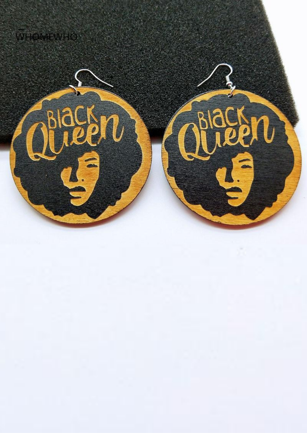 Wooden earrings with a graphic of a woman with an Afro and the words Black Queen emblazoned across the top.