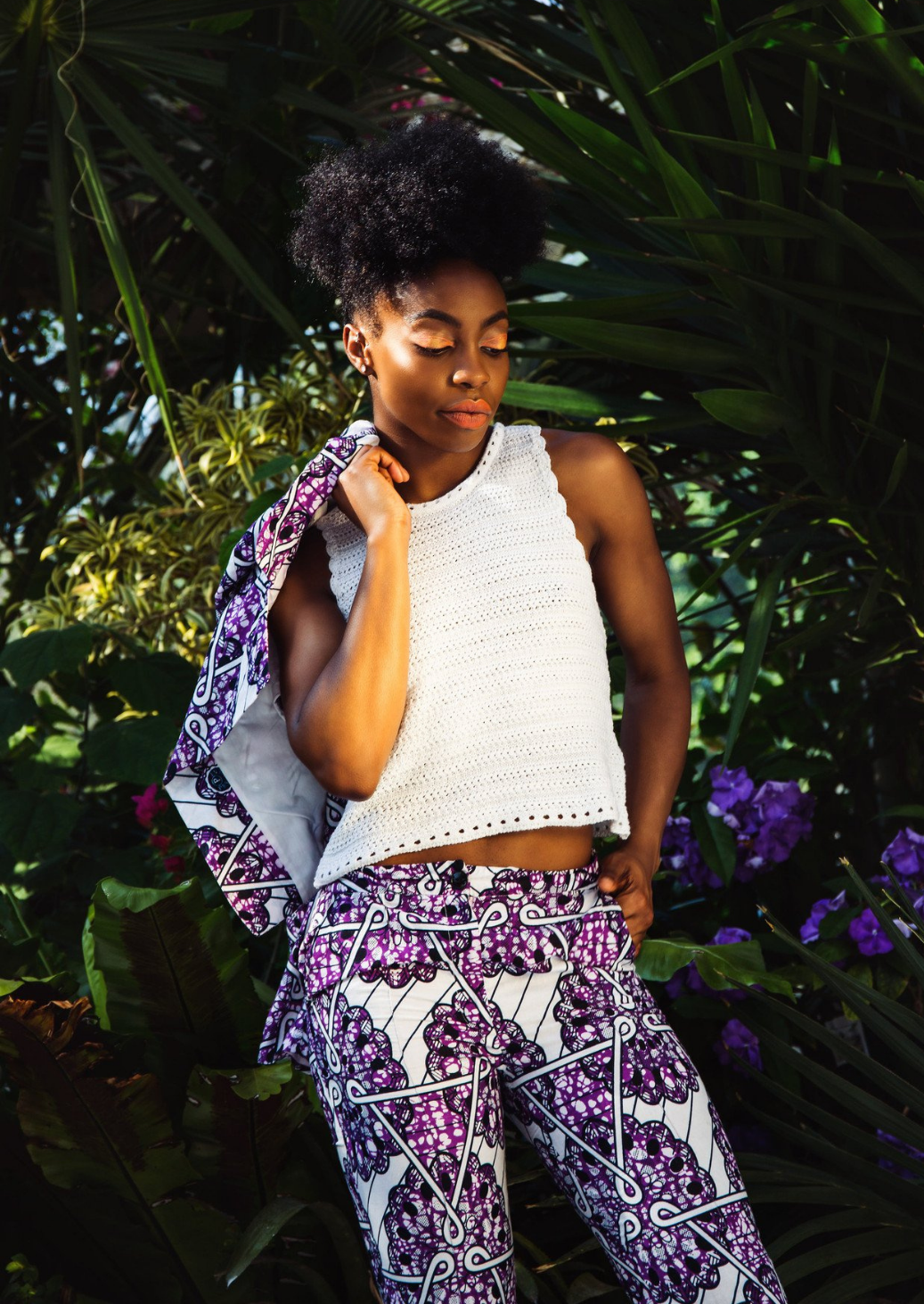 White trousers with a purple African print motif on the top.
