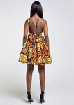 An orange multi way wrap dress, The Lola, is a versatile African print dress that can be styled to match your mood or the occasion. The Ankara style dress can be worn as a chic halter neck midi dress, a sleeveless v neck dress, a wrap dress, a bandeau midi dress, a cross front dress and more. The orange midi dress is perfect for work and social occasions and the wrap skater dress is made to measure.
