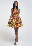 An orange multi way wrap dress, The Lola, is a versatile African print dress that can be styled to match your mood or the occasion. The Ankara style dress can be worn as a chic halter neck midi dress, a sleeveless v neck dress, a wrap dress, a bandeau midi dress, a cross front dress and more. The orange midi dress is perfect for work and social occasions and the wrap skater dress is made to measure.