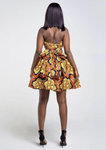 An orange multi way wrap dress, The Lola, is a versatile African print dress that can be styled to match your mood or the occasion. The Ankara style dress can be worn as a chic halter neck midi dress, a sleeveless v neck dress, a wrap dress, a bandeau midi dress, a cross front dress and more. The orange midi dress is perfect for work and social occasions and the wrap skater dress is made to measure.