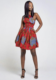 A red multi way wrap dress, The Lola, is a versatile African print dress that can be styled to match your mood or the occasion. The Ankara style dress can be worn as a chic halter neck midi dress, a sleeveless v neck dress, a wrap dress, a bandeau midi dress, a cross front dress and more. The red midi dress is perfect for work and social occasions and the wrap skater dress is made to measure.