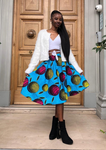 A light blue midi skirt with bold African print. The pleated midi skirt has pops of pink and yellow, making a statement African print dress.