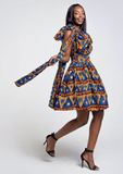 A blue African print multiway midi dress, our model wears the Ankara dress in blue, gold and red as a one shoulder dress.