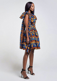 A blue African print multiway midi dress, our model wears the Ankara dress in blue, gold and red as a one shoulder dress.