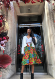 The Folu, a beautiful African print skirt, with tones of red, green, blue and yellow. The pleated midi skirt is bright and vibrant, the patchwork print making a beautiful flared skirt.