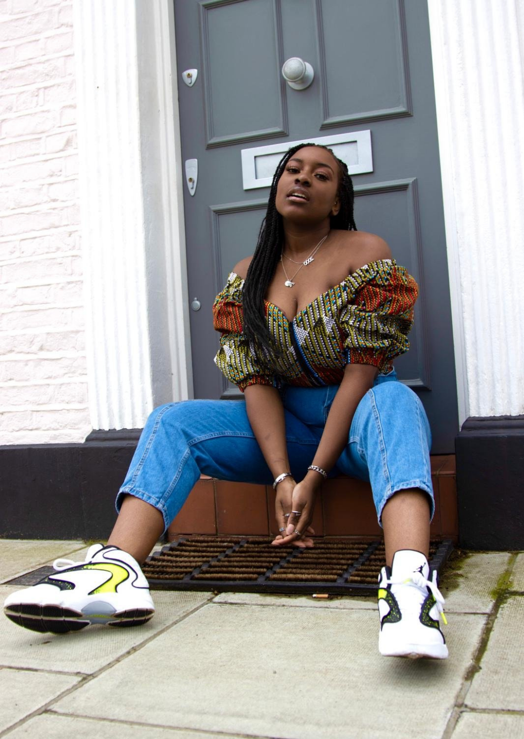 An orange and green off shoulder top, The Bola, with its striking African print brings a unique Ankara style orange and green bardot top to your wardrobe. The African print top with bardot neckline is the perfect long sleeve summer top, transcending seasons to provide you with an off shoulder blouse for all year round.