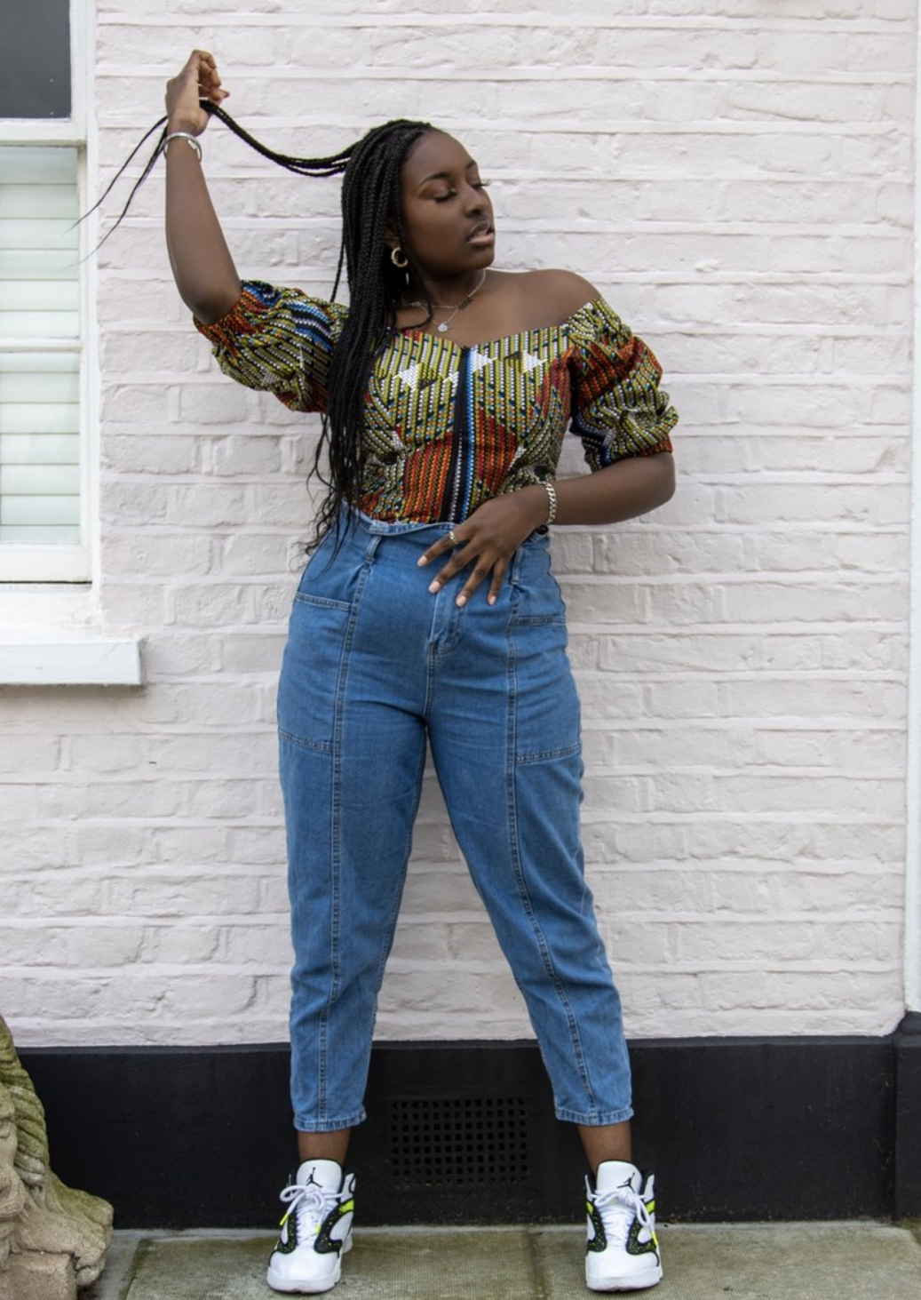 An orange and green off shoulder top, The Bola, with its striking African print brings a unique Ankara style orange and green bardot top to your wardrobe. The African print top with bardot neckline is the perfect long sleeve summer top, transcending seasons to provide you with an off shoulder blouse for all year round.