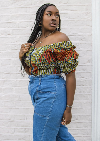 An orange and green off shoulder top, The Bola, with its striking African print brings a unique Ankara style orange and green bardot top to your wardrobe. The African print top with bardot neckline is the perfect long sleeve summer top, transcending seasons to provide you with an off shoulder blouse for all year round.