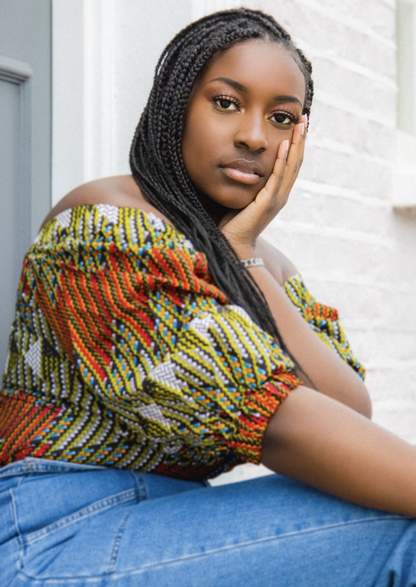 An orange and green off shoulder top, The Bola, with its striking African print brings a unique Ankara style orange and green bardot top to your wardrobe. The African print top with bardot neckline is the perfect long sleeve summer top, transcending seasons to provide you with an off shoulder blouse for all year round.
