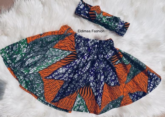 Orange African print a-line girls skirt with purple and green floral motif.