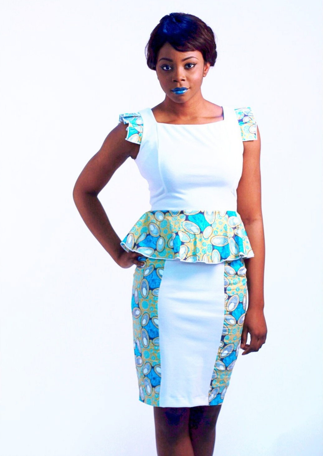 The Amira is a white peplum midi dress, the African print panelling on the peplum waist, sides of the skirt and pleated shoulders giving a unique twist to the white shift dress. The white midi dress is figure flattering, with a modern square neckline, making the white pencil dress a beautiful addition to your wardrobe. 