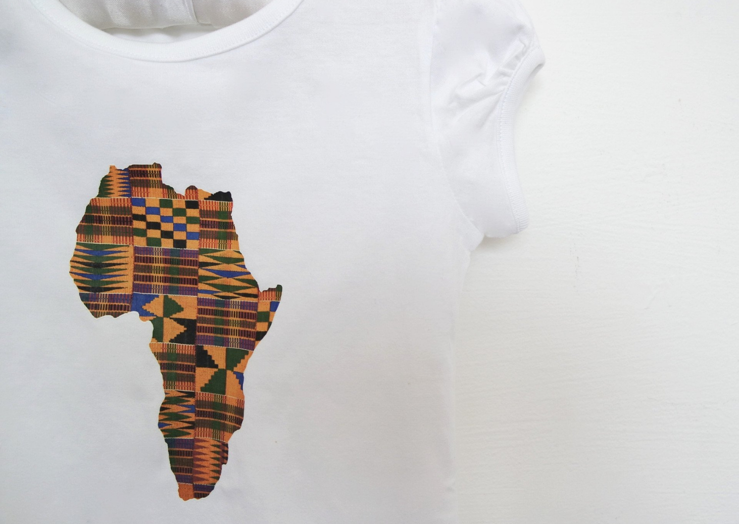Part of our African kids clothes range, The Anika is a white girls top with a kente print map of Africa in the centre. The short sleeve t shirt is the perfect girls summer top.